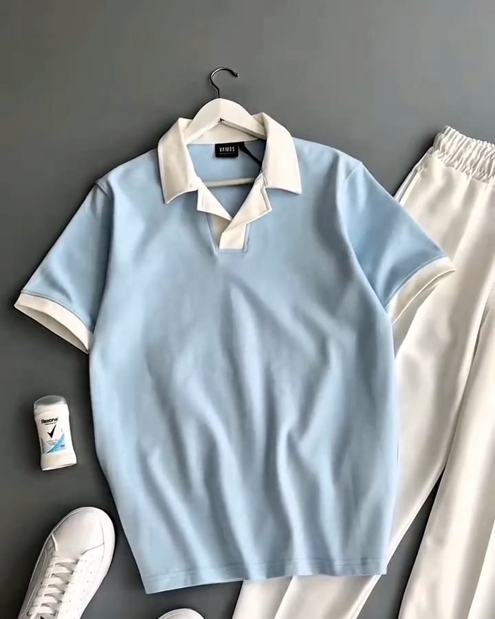 Sky blue knit polo with cream collar and cream trousers